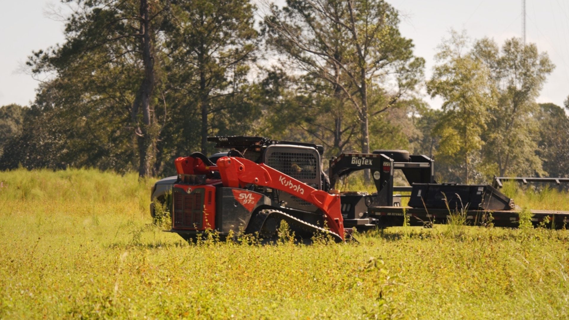 Forestry mulcher working a grassy tract of land